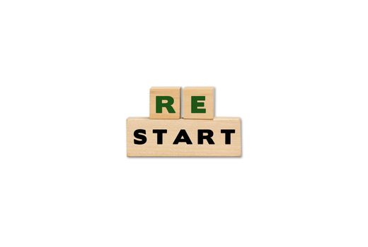 Restart symbol on wooden cubes. Business restart with copy space.