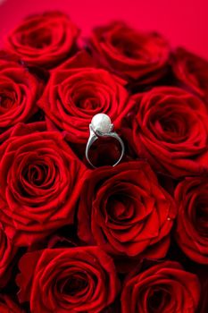 Gemstone jewellery, wedding present and engagement proposal concept - Beautiful white gold pearl ring and bouquet of red roses, luxury jewelry love gift on Valentines Day and romantic holidays