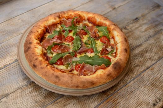 Very tasty pizza on a wooden background. High quality photo