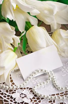 bouquet of white tulips with green leaves