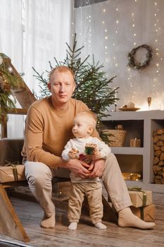 Dad and his little son in a magical Christmas atmosphere. The concept of family relations and New Year celebrations.