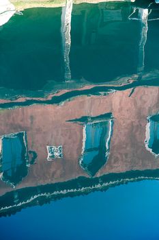 Buildings reflected on the water of one of the Murano canal