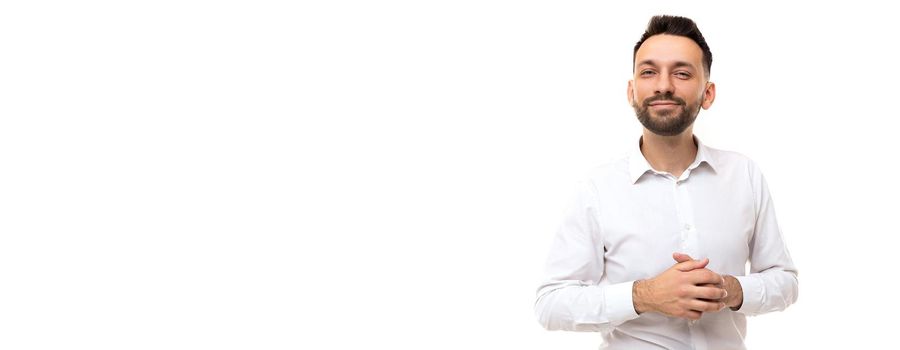 young businessman in a white shirt on a white background with his arms crossed on his chest demonstrate confidence and openness, Concept of non-toxic business and business qualities