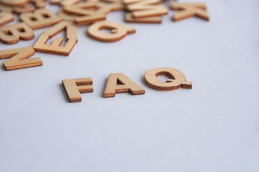 FAQ text on white background. Question and answer concept.