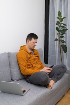 young man watching at mobile phone playing game. High quality photo