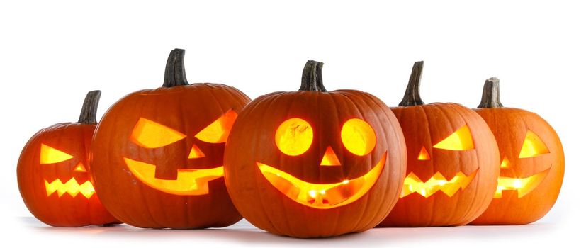 Five Halloween glowing lantern pumpkins in a row isolated on white background