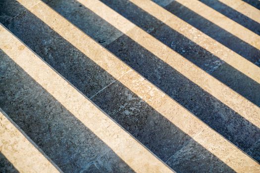 Staircase in the city, black and white pattern on the stairs on a sunny day