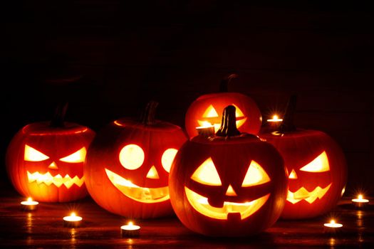 Halloween Jack O Lantern pumpkins and burning candles traditional decoration