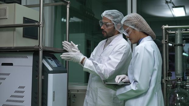 Two scientist in professional uniform working in laboratory for chemical and biomedical experiment