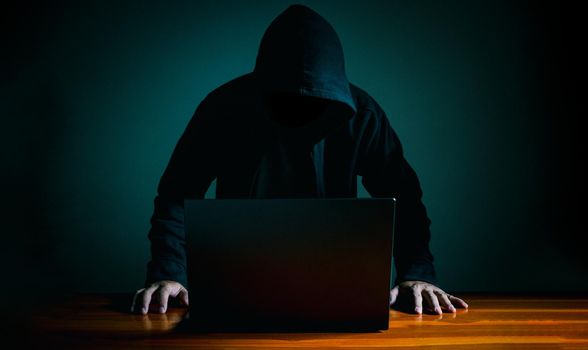 Hackers work on laptops in the dark. The concept of information security in the Internet network and information espionage.