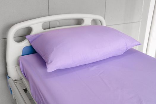 Empty patient bed in hospital room. Bed is for patient admitted to hospital for medical treatment