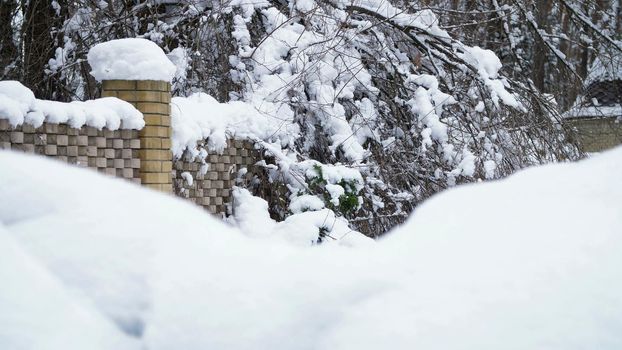 a beautiful winter landscape, a view of a sna beautiful winter landscape, a view of a snow-covered country house. The fence and the trees are all in the snow.ow-covered country house. The fence and the trees are all in the snow. High quality photo