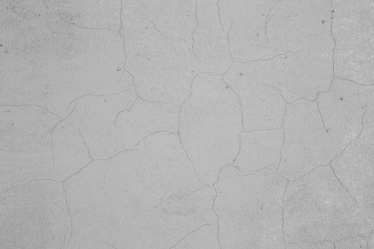 Old peeling paint on the wall. gray abstract background. Background from gray stucco.