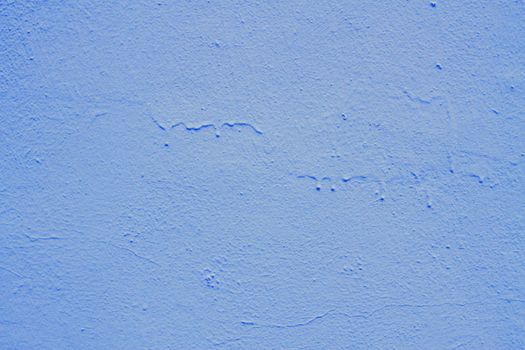 Blue abstract background. Beautiful blue textured plaster on the wall. Background from blue stucco..