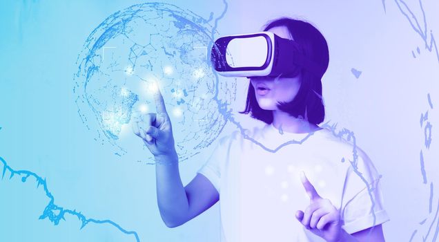 Potrait of asian woman in virtual reality glasses, pointing, choosing smth in VR headset, standing over white background.