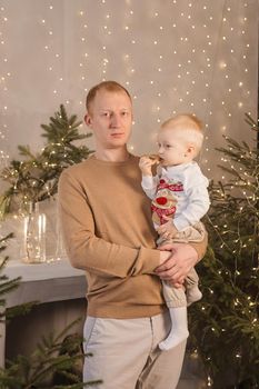 Dad and his little son in a magical Christmas atmosphere. The concept of family relations and New Year celebrations