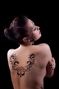 Studio portrait ot nude brunette woman with art makeup