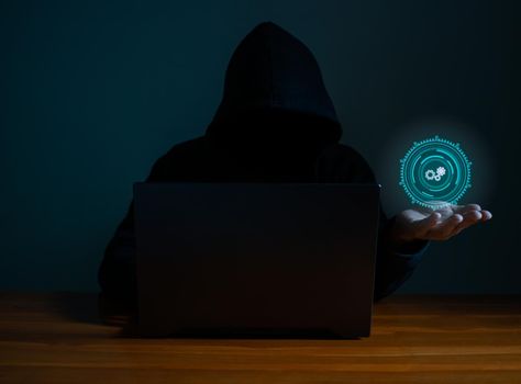 Hackers work on laptops in the dark. The concept of information security in the Internet network and information espionage.
