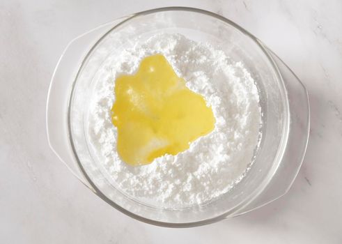step of Cooking icing for cookies, powdered sugar with whites in a bowl, homemade holiday baked good. High quality photo