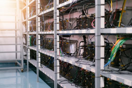 Bitcoin miners in farm.  ASIC mining equipment for cryptocurrency on racks steel container.  Blockchain technology concepts