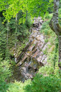 waterfall in the mountains of the mountain river. sochi rosa khutor mendelikha waterfalls park. photo