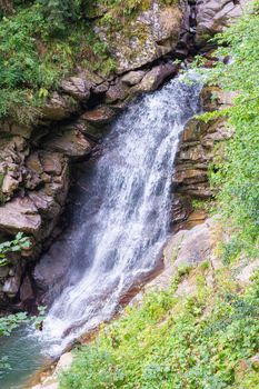 waterfall in the mountains of the mountain river. sochi rosa khutor mendelikha waterfalls park. photo