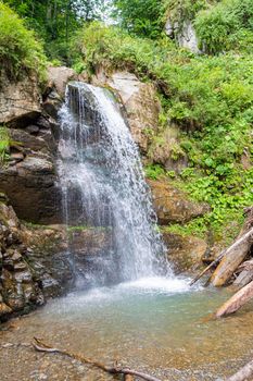 waterfall in the mountains of the mountain river. sochi rosa khutor mendelikha waterfalls park. photo