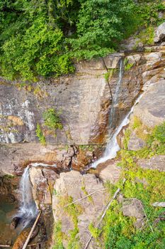 waterfall in the mountains of the mountain river. sochi rosa khutor mendelikha waterfalls park. photo