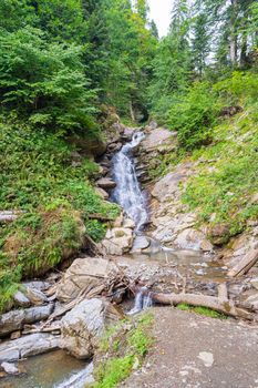 waterfall in the mountains of the mountain river. sochi rosa khutor mendelikha waterfalls park. photo