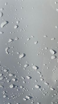 Water droplets perspective through white color surface good for multimedia content backgrounds, fresh dew