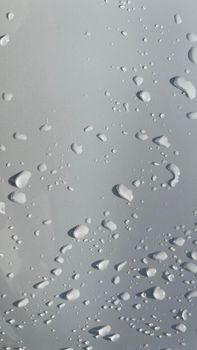 Water droplets perspective through white color surface good for multimedia content backgrounds, fresh dew