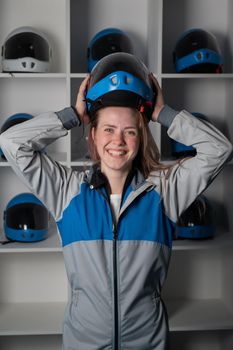 Caucasian woman puts on a helmet before flying in a wind tunnel. Free fall simulator