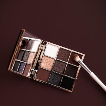 Cosmetic branding, mua and girly concept - Eyeshadow palette and make-up brush on chocolate background, eye shadows cosmetics product for luxury beauty brand promotion and holiday fashion blog design