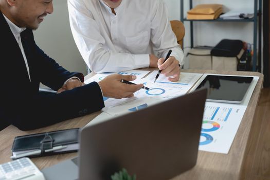 Asian business adviser meeting to analyze and discuss the situation on the financial report. Investment Consultant, Financial advisor and accounting concept