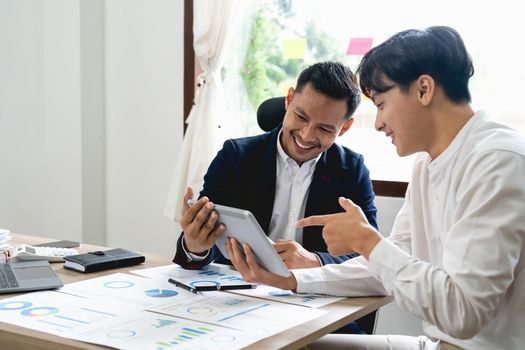 Asian business adviser meeting to analyze and discuss the situation on the financial report. Investment Consultant, Financial advisor and accounting concept
