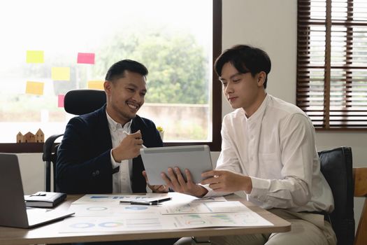 Asian business adviser meeting to analyze and discuss the situation on the financial report. Investment Consultant, Financial advisor and accounting concept