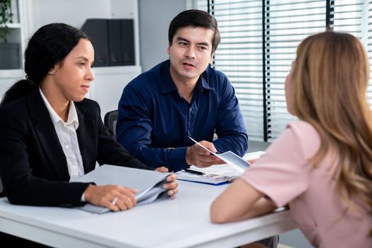 A young female asian candidate tries to impress her interviewer by being competent. International company, multicultural environment in workplace.