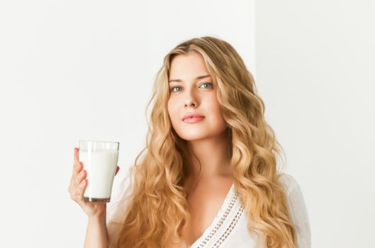 Diet, health and wellness concept, woman holding glass of milk or protein shake cocktail