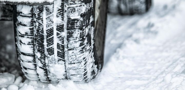 Perfect tread for a snow day. Closeup shot of a cars tyre in the snow