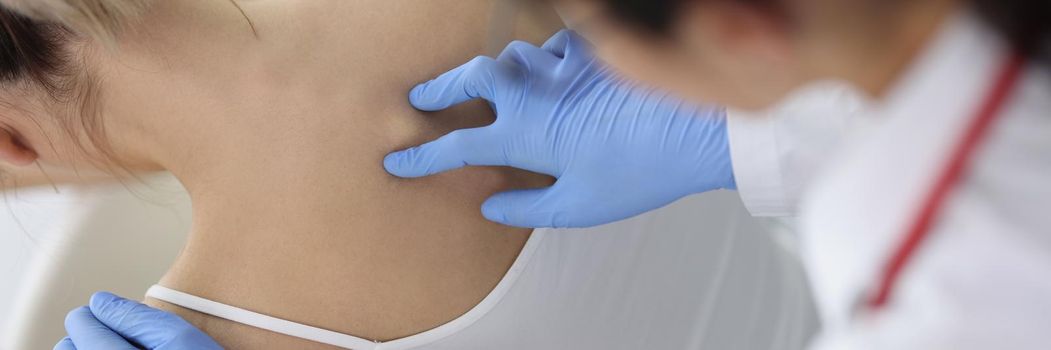 Chiropractor doctor presses on a woman's spine, close-up, top view. Osteochondrosis, physiotherapy in the clinic