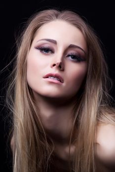 Portrait of beautiful blonde woman. Isolated on black