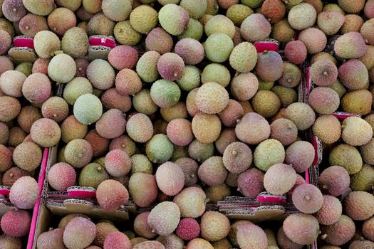 Pile of Lychee fruit, Litchi chinensis, for sale on a market stall