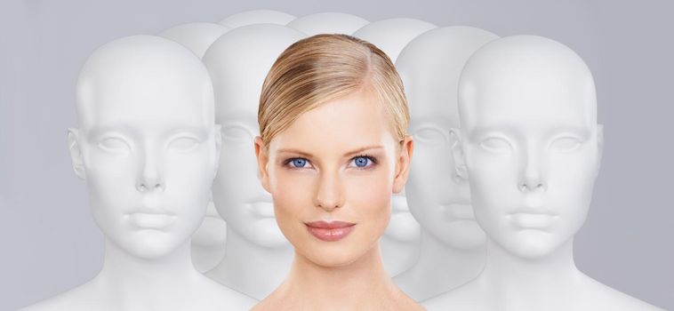 Bring your beauty to life. A young woman standing amongst a group of mannequins