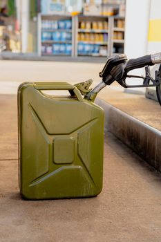 Refilling canister with fuel on the petrol station. Close up view. Fuel, gasoline, diesel is getting more expensive. Petrol industry and service. Petrol price and oil crisis concept