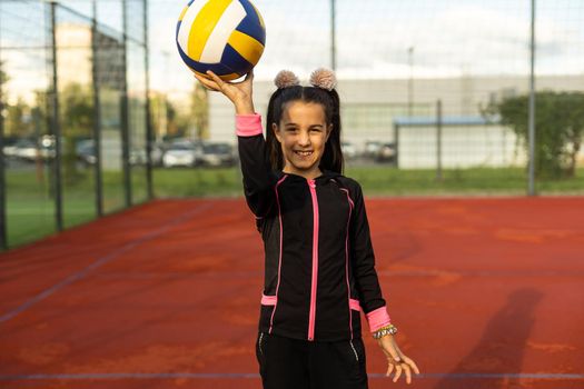 little girl with a volleyball ball