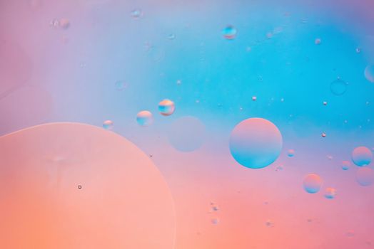 Oil drops in water. Defocused abstract psychedelic pattern image pastel colored. Abstract background with colorful gradient colors. DOF