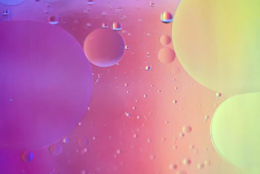 Oil drops in water. Abstract defocused psychedelic pattern image rainbow colored. Abstract background with colorful gradient colors. DOF.