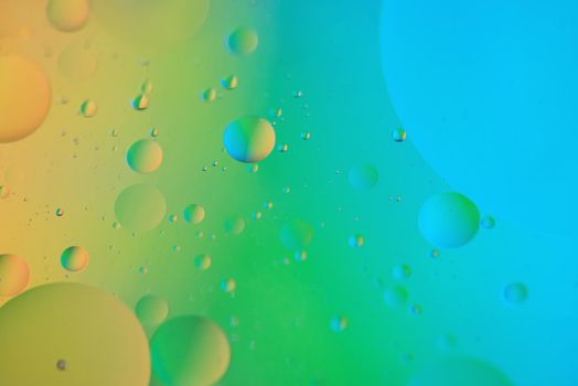 Oil drops in water. Abstract defocused psychedelic pattern image rainbow colored. Abstract background with colorful gradient colors. DOF.