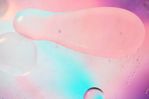 Oil drops in water. Defocused abstract psychedelic pattern image pastel colored. Abstract background with colorful gradient colors.