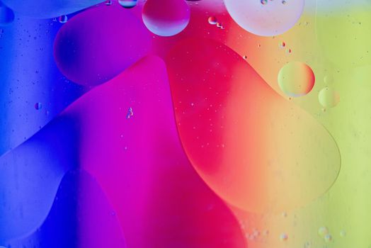 Oil drops in water. Abstract defocused psychedelic pattern image rainbow colored. Abstract background with colorful gradient colors. DOF